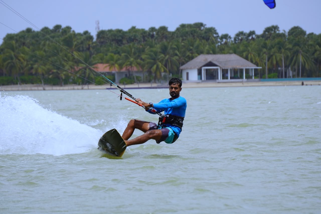Kitesurfer riding over flat water in Kalpitiya